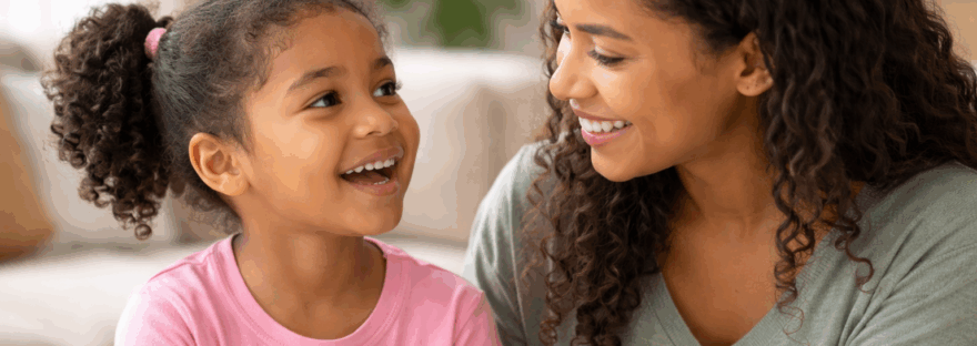 A mother helping her young daughter with speech therapy