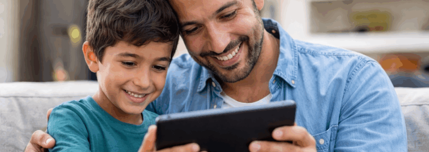 A son and father engaging in online therapy on their ipad.